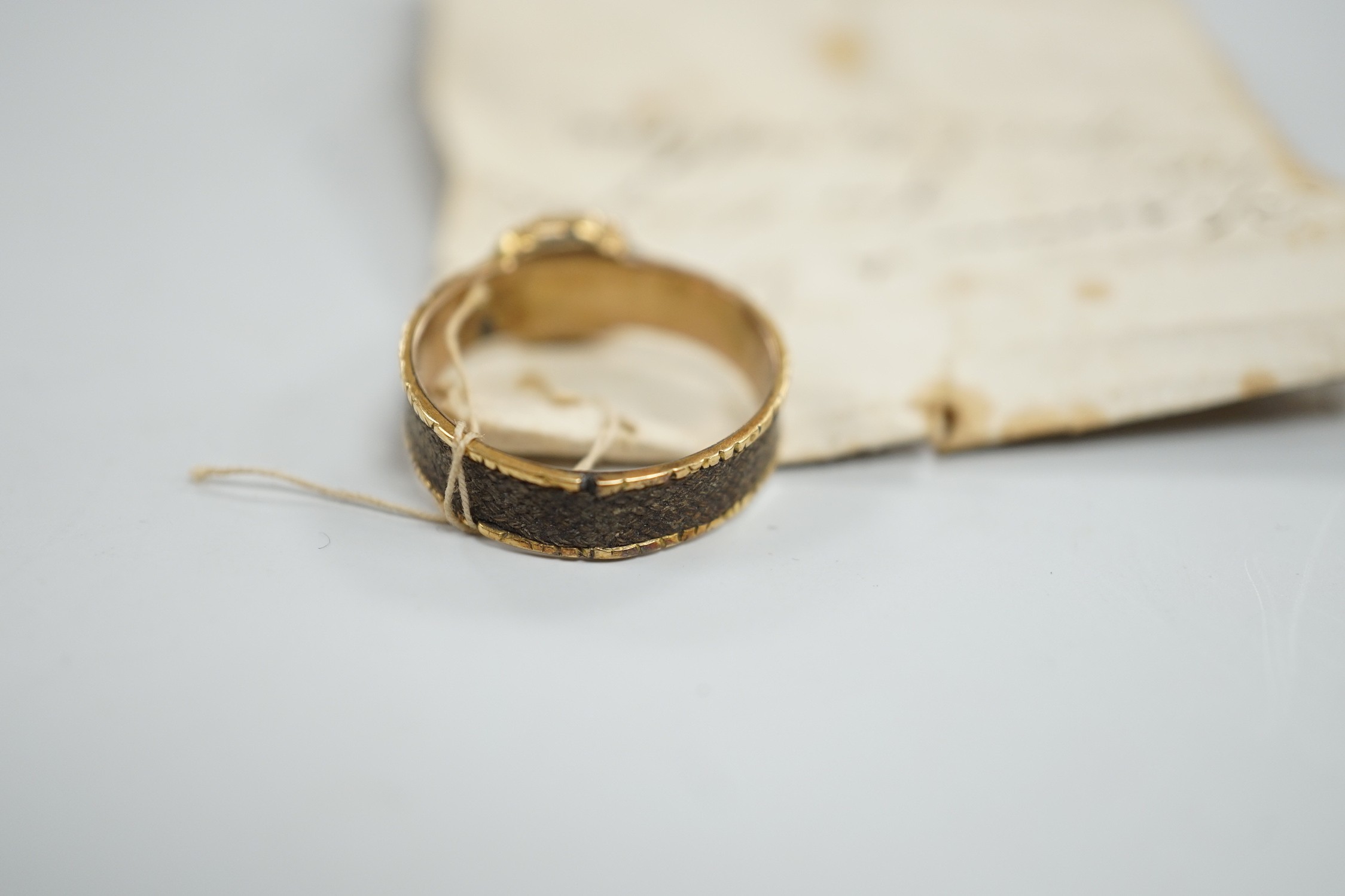 A 19th century yellow metal, split pearl and plaited hair set mourning ring, size O, gross weight 2.9 grams.